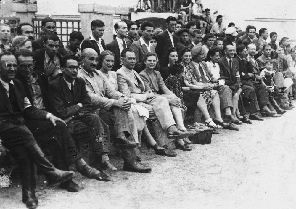 Jewish officials of the Vilna ghetto are seated in the audience at a sporting event